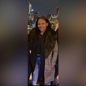 Women’s plaid overcoat with fur trim.